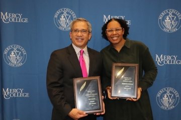 Man and woman with awards