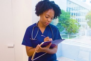 student nurse taking notes
